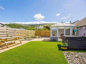 a backyard with a pool table and a wooden fence at 3 Bed in Fairbourne oc-86841 in Fairbourne