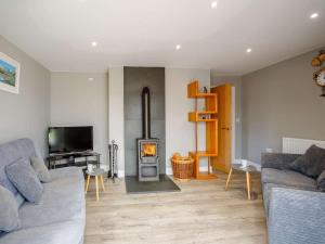 a living room with a couch and a fire place at 3 Bed in Fairbourne oc-86841 in Fairbourne