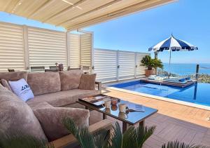 a living room with a couch and a swimming pool at Villa La Mer in Kalkan