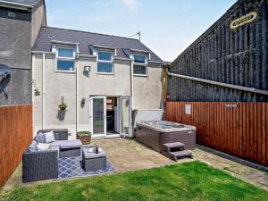 a backyard with a hot tub and a fence at 1 Bed in Swansea oc-52906 in Llanrhidian