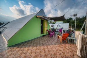 a building with colorful chairs and tables on a patio at Le Taïbit in Cilaos +15 photos