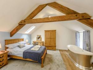 a bedroom with a bed and a bath tub at 1 Bed in Llanrwst oc-83950 in Llanrwst