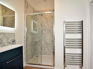 a shower with a glass door in a bathroom at 1 Bed in Llanrwst oc-83950 in Llanrwst +13 photos