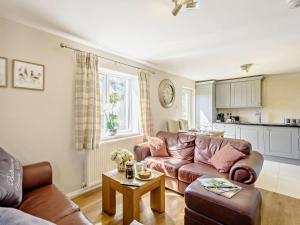 a living room with a couch and a table at 2 Bed in Holyhead oc-81515 in Caeʼr-geiliog