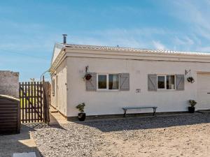 a white house with a bench in front of it at 2 Bed in Holyhead oc-81515 in Caeʼr-geiliog