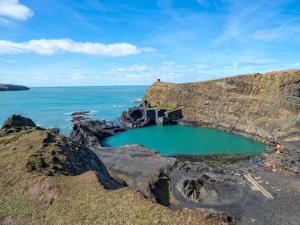 a small pool of water on a rocky shore at 1 Bed in Goodwick oc-fb158 in Goodwick