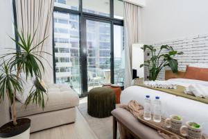 a hotel room with a bed and a couch at Luxurious Studio Hidden Condo In Dubai in Dubai