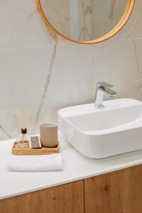 a bathroom with a white sink and a mirror at Casa D'Almo in Almograve +8 photos