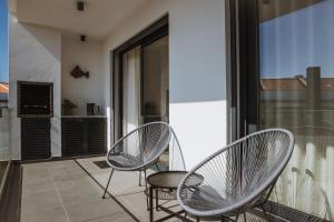two chairs and a table on a balcony at Casa D'Almo in Almograve