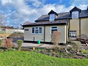 a detached house with a garden in front of it at 1 Bed in Conwy oc-79357 in Llangelynin