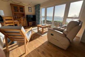 a living room with a couch and a table at Cliffside Garden Flat in Woolacombe