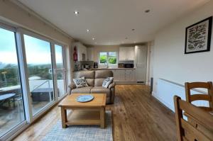 a living room with a couch and a table at Cliffside Garden Flat in Woolacombe