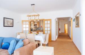 a living room with a couch and a table at Sunny Ocean view, Praia del Rey A7 in Óbidos