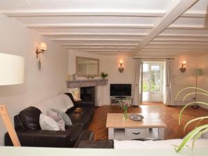 a living room with a couch and a fireplace at 3 Bed in Conwy oc-tygos in Llangelynin