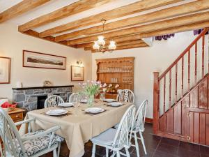 a dining room with a table and chairs and a fireplace at 2 Bed in Colwyn Bay oc-50933 in Eglwys-Fâch