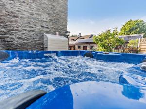 a hot tub filled with water in a yard at 2 Bed in Colwyn Bay oc-50933 in Eglwys-Fâch