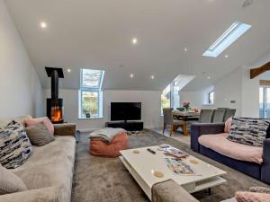 a living room with a couch and a table at 4 Bed in Llandovery oc-90307 in Myddfai