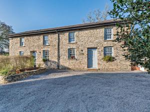 a stone house with a driveway in front of it at 4 Bed in Llandovery oc-90307 in Myddfai