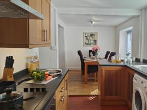 a kitchen with a table and a dining room at 3 Bed in Aberaeron oc-95971 in Aberaeron
