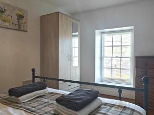 a bedroom with a bed with two pillows on it at 3 Bed in Aberaeron oc-95971 in Aberaeron +17 photos