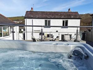 a hot tub in front of a house at 3 Bed in Aberaeron oc-95971 in Aberaeron