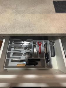 a drawer filled with utensils on a counter at Ana Lux Master Apartment 14 in Podgorica