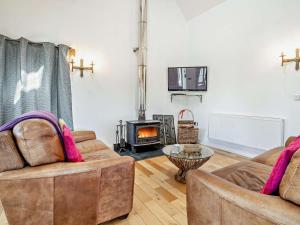 a living room with two couches and a fireplace at 1 Bed in Narberth oc-72867 in Whitland