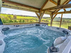 a hot tub in a gazebo at 1 Bed in Narberth oc-72867 in Whitland