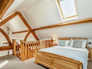 a bedroom with a wooden bed and a skylight at 1 Bed in Narberth oc-72867 in Whitland +17 photos
