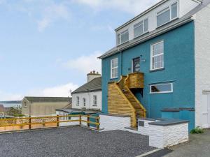 a blue house with a staircase on the side of it at 3 Bed in New Quay oc-83998 in New Quay