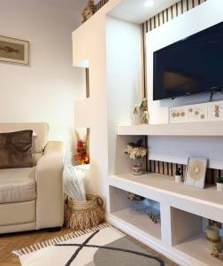 a living room with a tv on a wall at Sleep & Go Floreasca Green in Bucharest