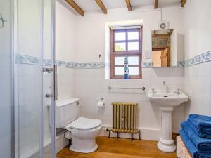 a bathroom with a toilet and a sink at 1 Bed in Swansea oc-77981 in Penclawdd +29 photos