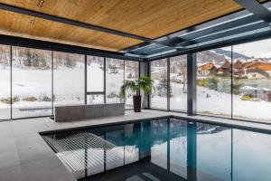 a swimming pool in a house with a view at Cristallo Wellness Hotel in Aprica