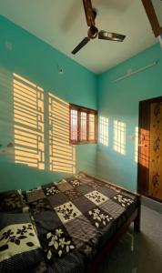 a bedroom with a bed in a room with blue walls at STAR Residency - G in Pondicherry