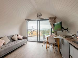 a living room with a couch and a table at 1 Bed in Corwen oc-80320 in Gwyddelwern