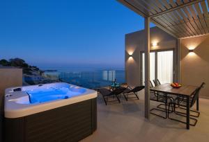a jacuzzi tub in the middle of a living room at Aquamarine Luxury Suites - Stegna - Beachfront, Jacuzzi , Smart Home, Great View in Archangelos