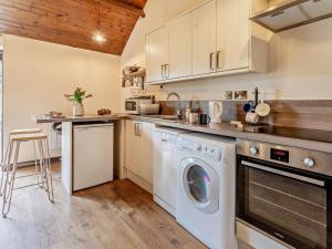 a kitchen with a washer and dryer at 1 Bed in Swansea oc-74221 in Ilston +15 photos