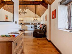 a living room with a couch and a kitchen at 1 Bed in Swansea oc-74221 in Ilston
