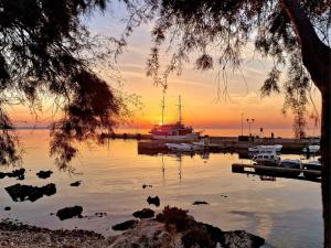 a boat is docked at a marina at sunset at Guest House Tiho in Silba +15 photos