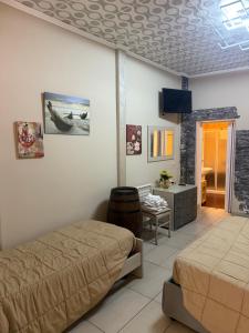 a bedroom with two beds and a tv in it at Luxury Apartment Golden Dreams in Reggio di Calabria