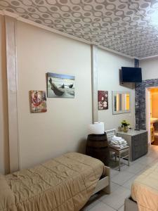 a bedroom with a bed and a tv in a room at Luxury Apartment Golden Dreams in Reggio di Calabria