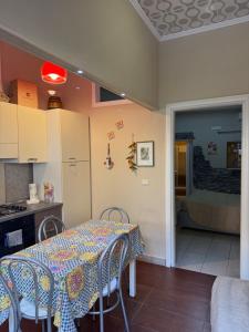 a kitchen with a table and chairs in a kitchen at Luxury Apartment Golden Dreams in Reggio di Calabria