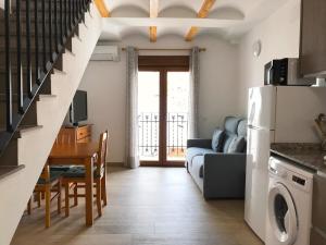 a kitchen and living room with a couch and a table at Alojamiento con terraza en Chulilla in Chulilla