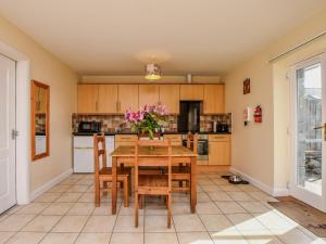 a kitchen with a wooden table and chairs at 2 Bed in Bala oc-86964 in Llandderfel