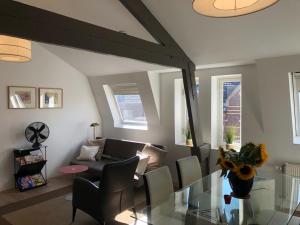 a living room with a glass table and a couch at inn Venlo Apartment in Venlo