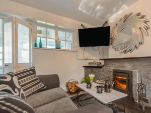 a living room with a couch and a fireplace at 2 Bed in Mold oc-90461 in Caerwys