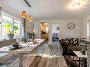 a living room with a table and a couch at 2 Bed in Mold oc-90461 in Caerwys