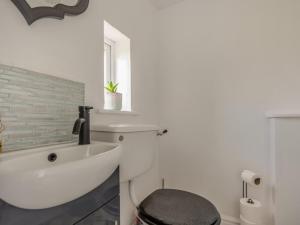 a white bathroom with a sink and a toilet at 2 Bed in Mold oc-90461 in Caerwys +19 photos