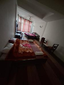 a living room with a bed and a couch at Kalinga Intercontinental By Maa Vaishno Hotels India Pvt Ltd in Manāli