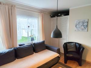 a living room with a couch and a window at Ferienwohnung Seerose mit Terrasse in Sassnitz